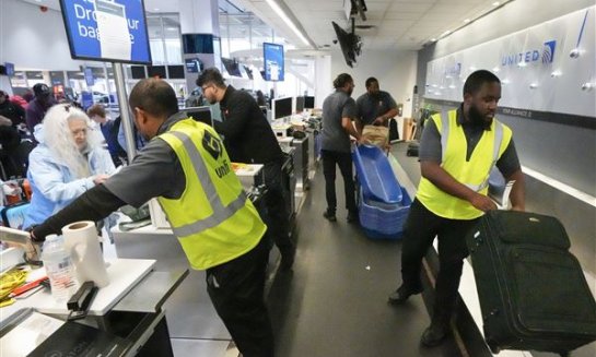 Passenger drop off their baggage at United Airlines in C Terminal at George Bush Intercontinental Airport, Dec. 21, 2023, in Houston.